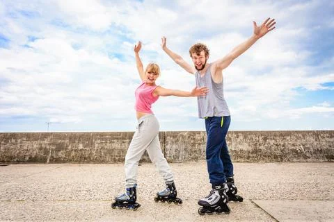 Active young people friends rollerskating outdoor. Stock Photos