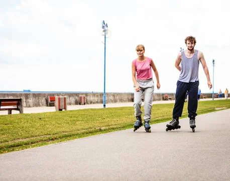 Active young people friends rollerskating. Stock Photos
