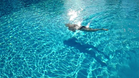 Active young woman diving in pool Stock Footage 195029925