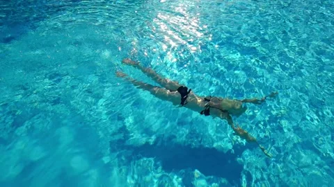 Active young woman diving in pool Stock Footage 195029926