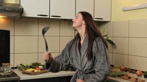 Active young woman preparing dinner on kitchen and dancing, hobby, good mood. Stock Footage 299920296