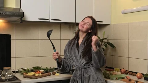 Active young woman preparing dinner on kitchen and dancing, hobby, good mood. Stock Footage 307786249