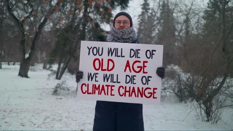 Activist is demonstrating an inspirational message written on the white banner Stock Footage 164772685