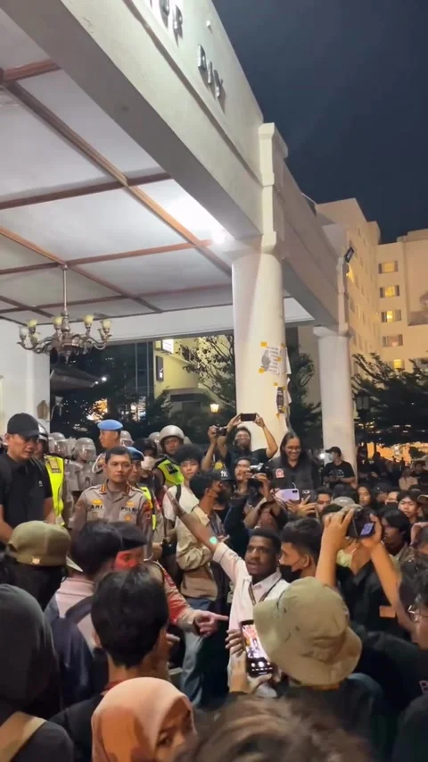Activists Gather Outside DPRD DIY Building at Night Facing Police Stockbeeldmateriaal 348288728