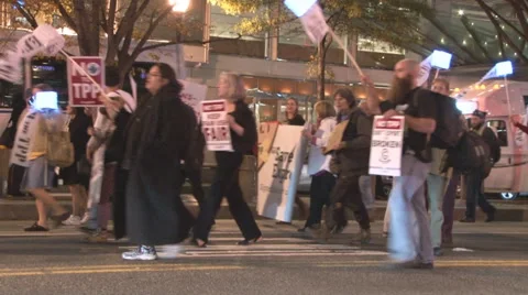 Activists protest the T.P.P. and walk in traffic in Washington.  Stock Footage 57979602