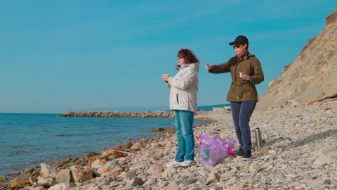 Activists remove trash from a remote beach, preventing an environmental disaster Stock Footage 308283625