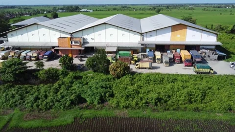 Activities in the warehouse area include loading industrial goods into tran.. 動画素材 312215638