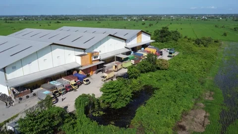 Activities in the warehouse area include loading industrial goods into tran.. 動画素材 312215733