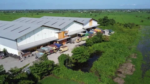 Activities in the warehouse area include loading industrial goods into tran.. 動画素材 312215823
