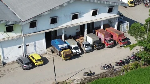 Activities in the warehouse area include loading industrial goods into tran.. 動画素材 312215861