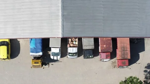 Activities in the warehouse area include loading industrial goods into tran.. 動画素材 312215926