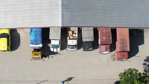 Activities in the warehouse area include loading industrial goods into tran.. 動画素材 312215968
