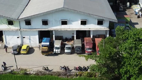 Activities in the warehouse area include loading industrial goods into tran.. 動画素材 312215993
