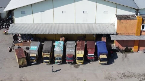 Activities in the warehouse area include loading industrial goods into tran.. 動画素材 312216045