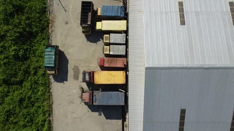 Activities in the warehouse area include loading industrial goods into tran.. 動画素材 312216053