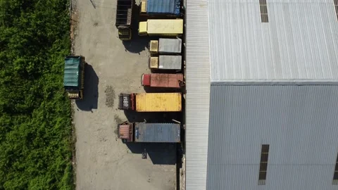 Activities in the warehouse area include loading industrial goods into tran.. 動画素材 312216064
