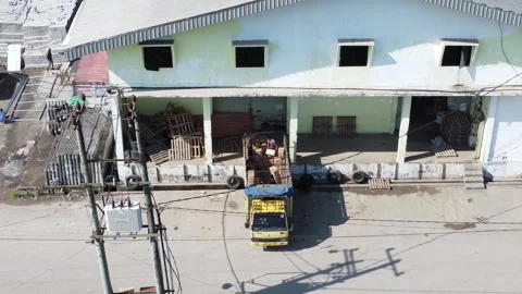 Activities in the warehouse area include loading industrial goods into tran.. 動画素材 312216106