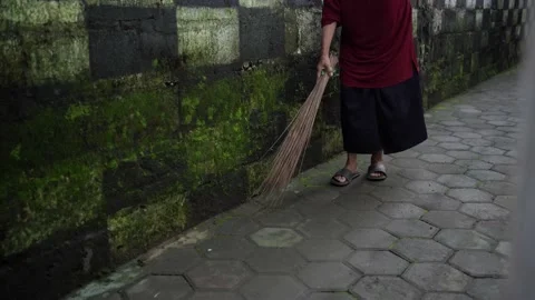 Activities of women sweeping using a broom stick on the porch of the house Stock Footage 145958528