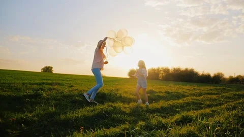 Activity at any age. A middle-aged woman is playing with her daughter, running Stock Footage 75305856