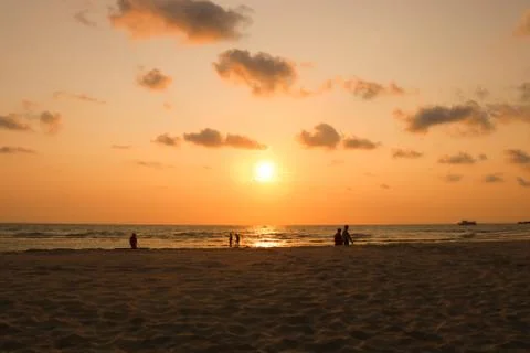Activity on the beach at sunset time. silhouette of people on beach. Foto stock