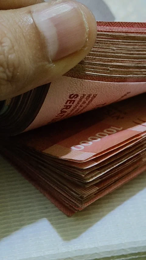 Activity of checking a stack of one hundred thousand rupiah Stock Footage 308051923