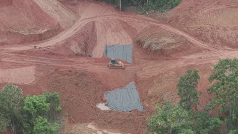 The activity of a crawler bulldozer leveling the fill soil transported by a.. Stock Footage 334922292