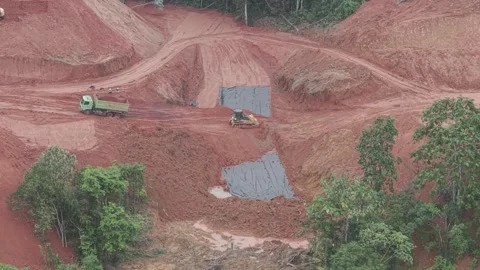 The activity of a crawler bulldozer leveling the fill soil transported by a.. Stock Footage 334922380