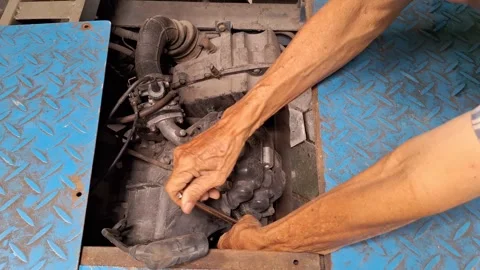 The activity of a man who is trying to open a spark plug Stock Footage 262445357