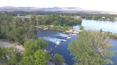 Activity on Rivers Edge Biking, Surfing, Swimming, Paddle boarding Stock Footage 100090229
