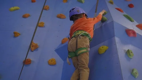 Activity of rock-climbing on artificial climbing walls, Caucasian boy in a Stock Footage 106840349