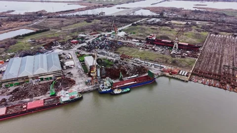 Activity at shipyard shows vessels docked for cargo transport and repair Stock Footage 337942573