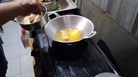 The activity of someone frying bananas in the kitchen Stock Footage 258333773