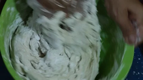 The activity of someone's hands mixing flour mixture in a container Stock Footage 276587537