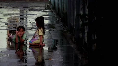 The activity of two children chatting while playing when it rains Stock Footage 236875626
