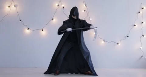An actor dressed as the grim reaper dances funny Stock Footage 279339019