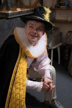 Actor dressed historical costume in interior of old theater. Stock Photos
