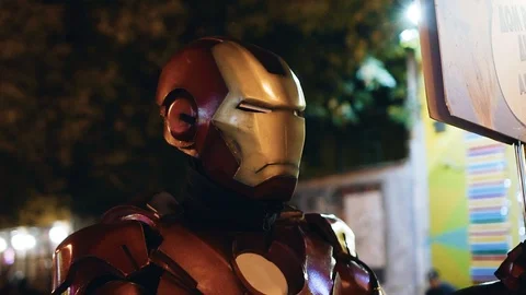 Actor dressed as iron man on the evening street of the city Stock Footage 115527757