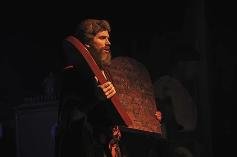 Actor dressed as Moses holding stage props of the Biblical Ten Commandments Stock Photos