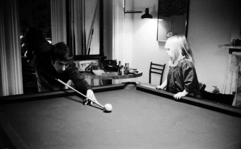 Actor Dustin Hoffman playing pool while his step daughter Karina Hoffman is stan Stock Photos