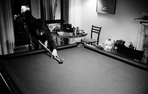 Actor Dustin Hoffman playing pool while his step daughter Karina Hoffman is stan Stock Photos