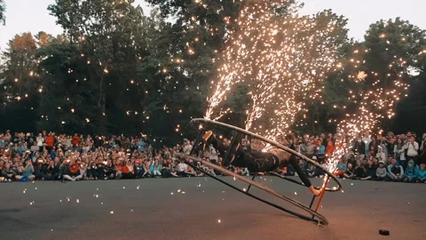 Actor of fire show performs trick with wheel and sparklers, sparklers sparkles. Stock Footage 160804331