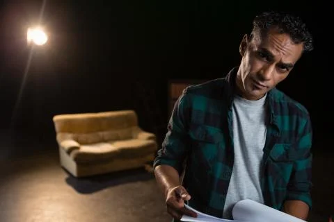 Actor holding his scripts on stage Stock Photos