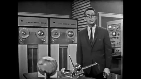 Actor John Fitch explains a midcourse maneuver as scientists and engineers in Stock Footage 79517090