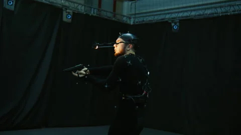 Actor in motion capture suit acting as a game or animation movie character Stock Footage 166023338