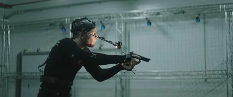 Actor in motion capture suit acting as a game or animation movie character Stock Footage 166099807
