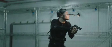 Actor in motion capture suit acting as a game or animation movie character Stock Footage 166099900