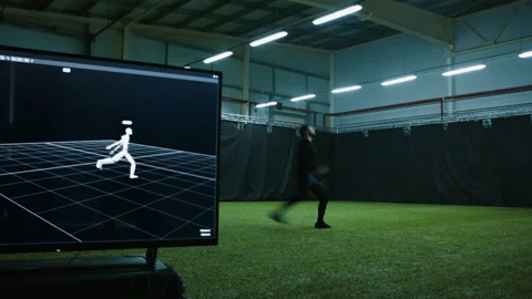 Actor in motion capture suit performing some stunt moves as a game character Stock Footage 166023574