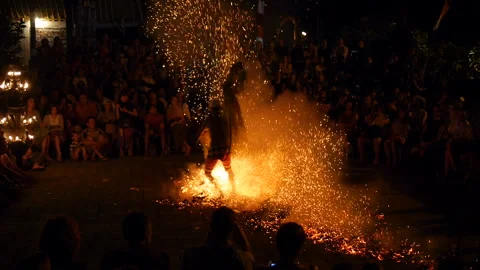 Actor performs walking on redhot coals on stage for tourists Video stock 102488603