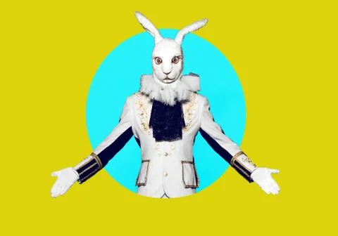 Actor posing in white rabbit suit on color yellow blue background.Studio shot Stock Photos
