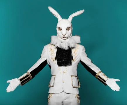 Actor posing in white rabbit suit on color blue background.Studio shot.Halloween Stock Photos